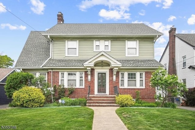 29 Rutgers St, Maplewood Twp, NJ 07040 - view of front facade with brick siding, a front yard, and a shingled roof