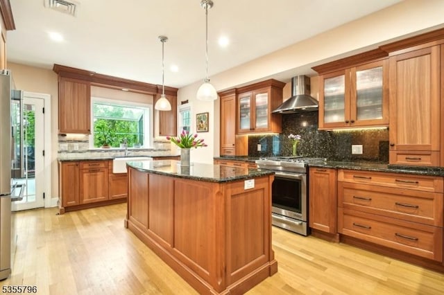 29 Rutgers St, Maplewood Twp, NJ 07040 - kitchen with high end range, wall chimney exhaust hood, a center island, light wood finished floors, and tasteful backsplash