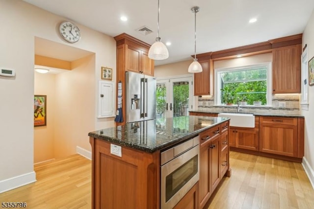 29 Rutgers St, Maplewood Twp, NJ 07040 - kitchen with appliances with stainless steel finishes, a sink, backsplash, light wood finished floors, and recessed lighting