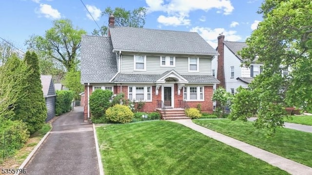 29 Rutgers St, Maplewood Twp, NJ 07040 - view of front of home with brick siding, a front lawn, and a chimney
