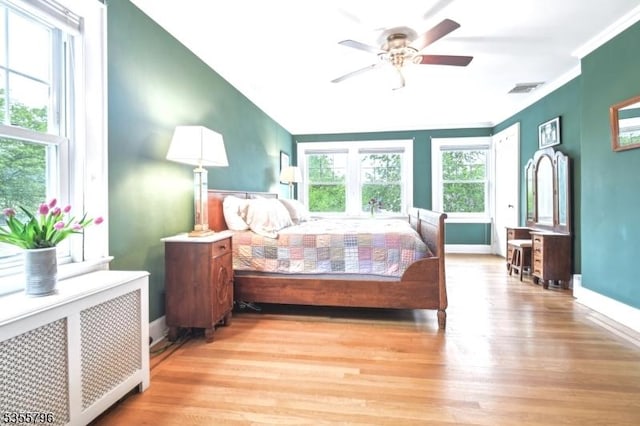 29 Rutgers St, Maplewood Twp, NJ 07040 - bedroom featuring radiator, wood finished floors, baseboards, crown molding, and a ceiling fan