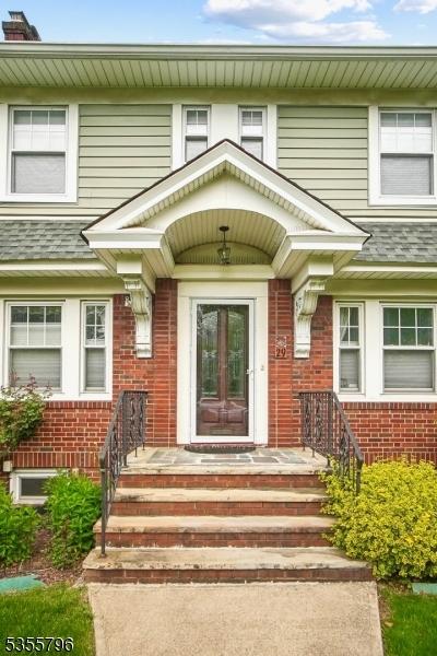 29 Rutgers St, Maplewood Twp, NJ 07040 - property entrance featuring brick siding and a shingled roof