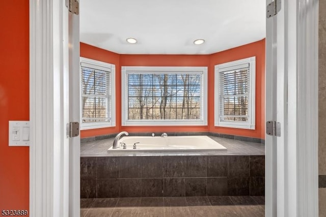 full bathroom with a bath and a wealth of natural light