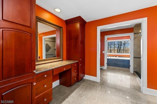 hallway featuring baseboards and light tile patterned floors