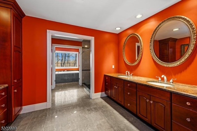 bathroom featuring double vanity, baseboards, tile patterned flooring, and a sink
