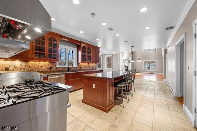 kitchen featuring visible vents, recessed lighting, decorative backsplash, a kitchen island, and appliances with stainless steel finishes