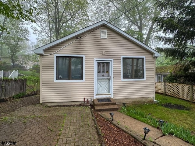 rear view of property featuring fence