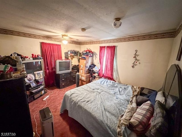 carpeted bedroom with a textured ceiling and ceiling fan
