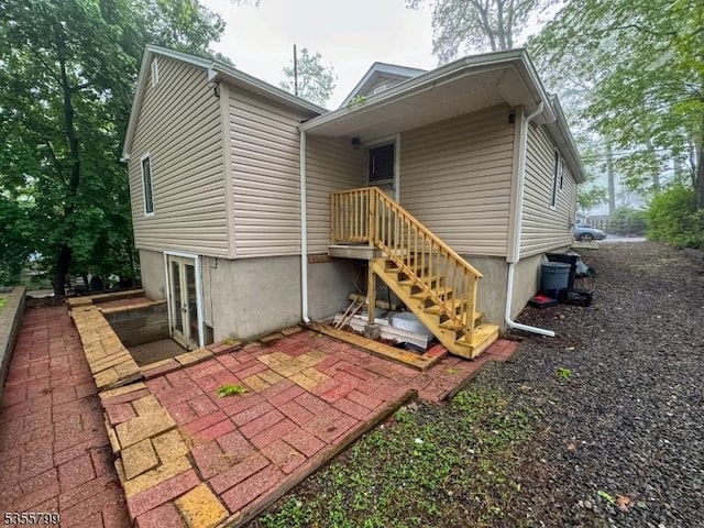 rear view of property with french doors and a patio