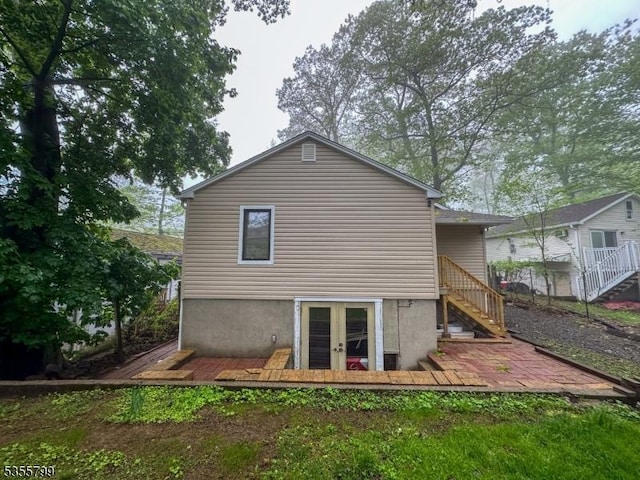 back of house featuring stairs and french doors