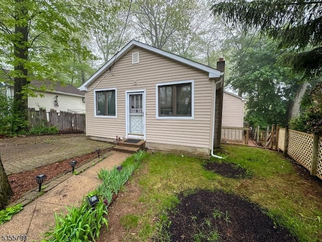 back of property with a chimney
