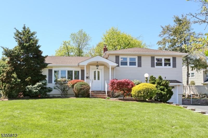 4 Hemlock St, Waldwick Boro, NJ 07463 - split level home with a front lawn and a chimney