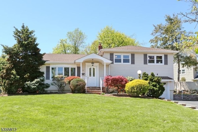 4 Hemlock St, Waldwick Boro, NJ 07463 - split level home with a front lawn and a chimney