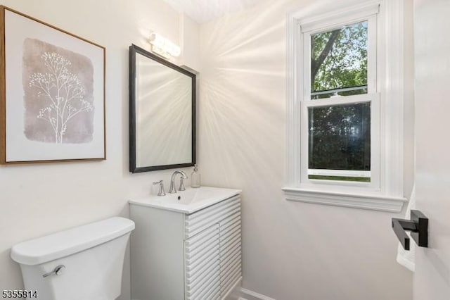 bathroom featuring toilet and vanity