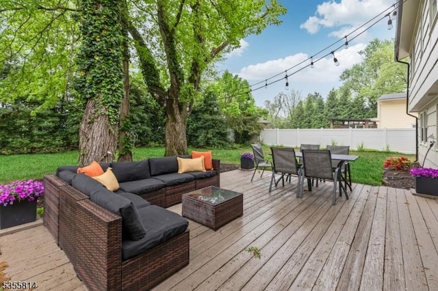 deck with an outdoor hangout area, outdoor dining area, and a fenced backyard
