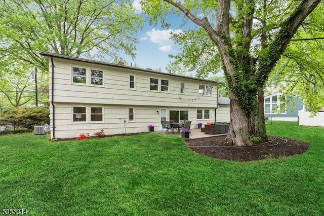 rear view of house featuring a patio area, a lawn, and cooling unit