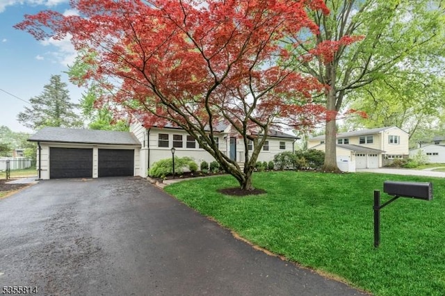 view of front of home featuring driveway and a front lawn