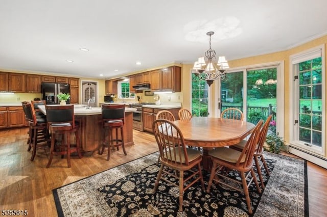 1078 Mountain Ave, Berkeley Heights Twp, NJ 07922 - dining room with a chandelier, healthy amount of natural light, light wood finished floors, recessed lighting, and crown molding