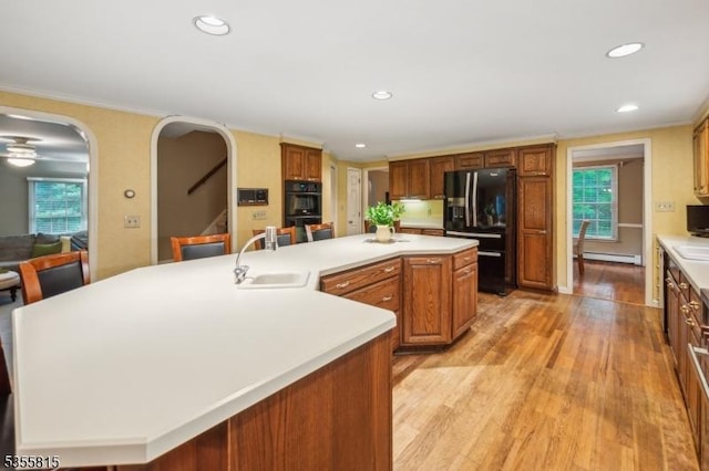 1078 Mountain Ave, Berkeley Heights Twp, NJ 07922 - kitchen featuring black appliances, a sink, baseboard heating, a large island, and light wood-style flooring