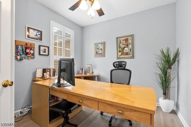office featuring baseboards, ceiling fan, and wood finished floors
