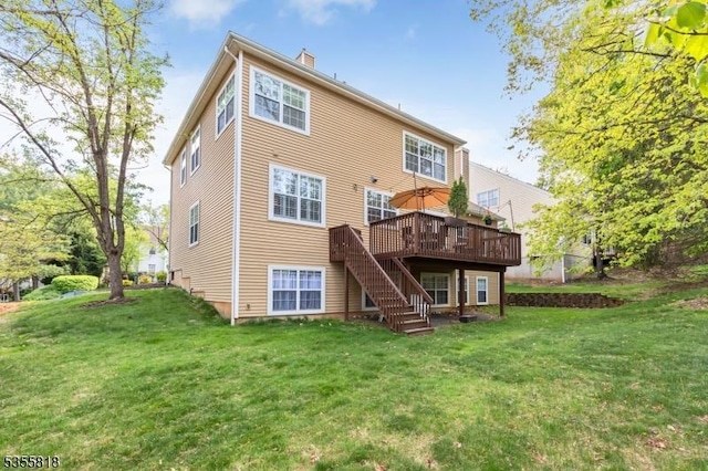 back of house featuring a yard, stairway, a chimney, and a wooden deck