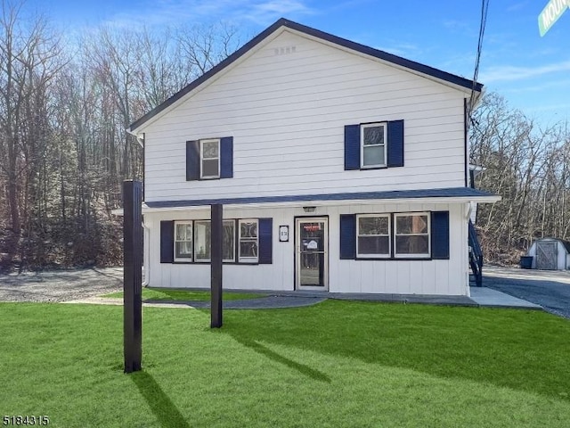 traditional home featuring board and batten siding and a front yard