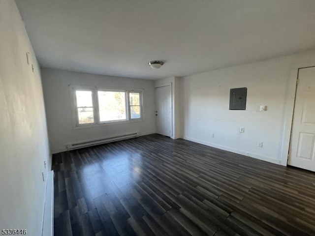 empty room with electric panel, baseboards, dark wood-style floors, and a baseboard heating unit