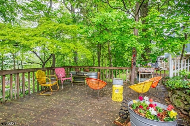 view of patio / terrace featuring a deck and view of scattered trees