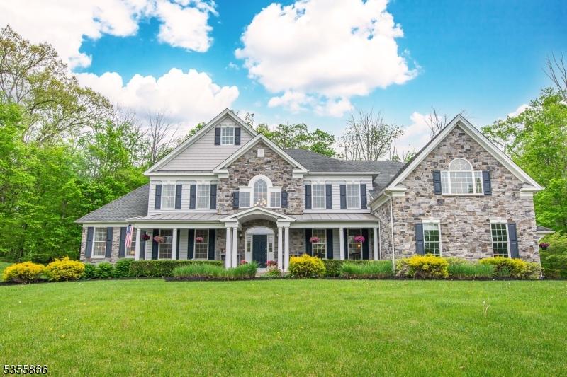 6 Limekiln Ct, Green Twp, NJ 07821 - view of front of house with covered porch, a standing seam roof, stone siding, and a front yard