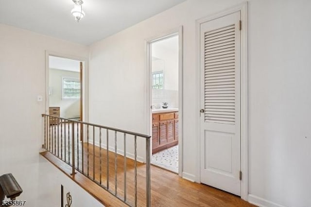 7 Fairhaven Dr, Parsippany-Troy Hills Twp, NJ 07950 - hall with an upstairs landing, wood finished floors, and baseboards