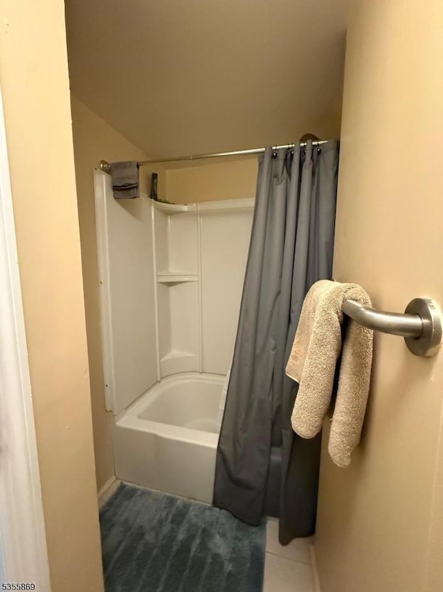 full bathroom featuring shower / tub combo, baseboards, and tile patterned flooring