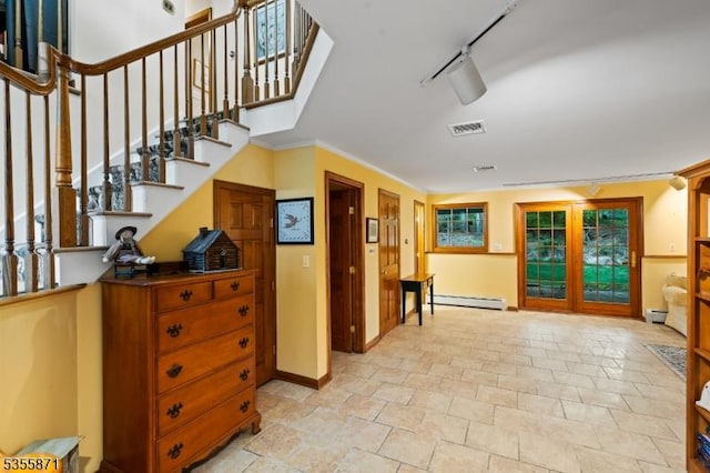 entryway with stone tile flooring, baseboard heating, stairway, and a baseboard radiator