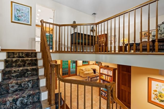staircase with lofted ceiling