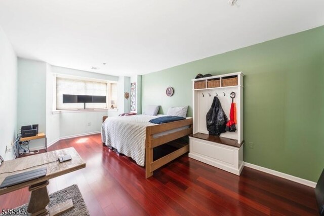 bedroom featuring wood finished floors and baseboards
