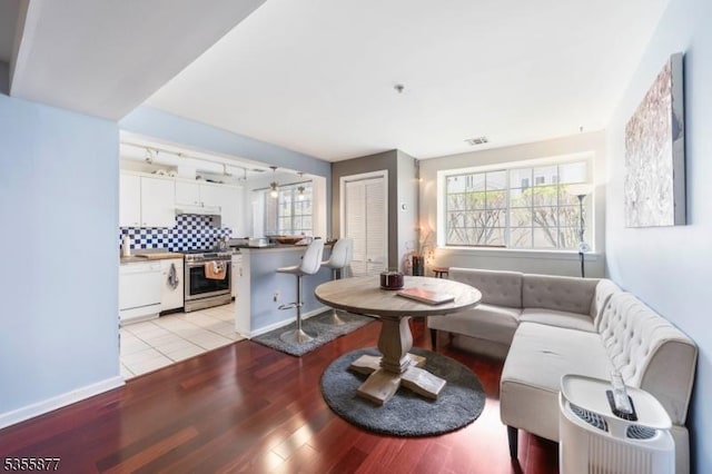 living room featuring light wood-type flooring and baseboards