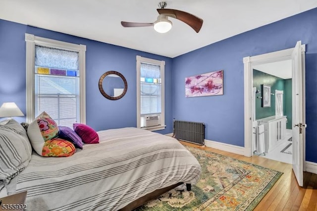 128 W High St, Somerville Boro, NJ 08876 - bedroom with radiator, wood finished floors, baseboards, ensuite bathroom, and a ceiling fan