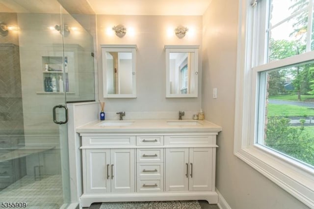 full bathroom featuring a stall shower and double vanity