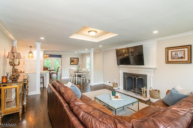 living room with crown molding, dark wood-type flooring, recessed lighting, baseboards, and a fireplace with raised hearth