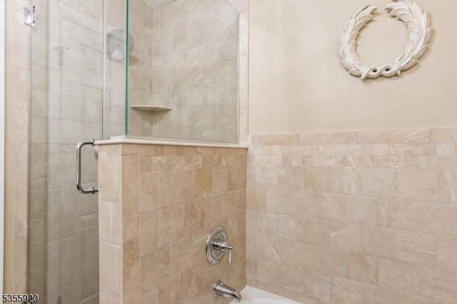 bathroom featuring shower / bath combination with glass door