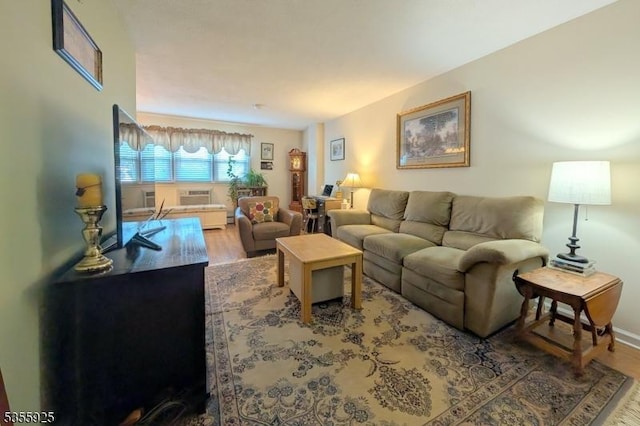 living room featuring wood finished floors and baseboards