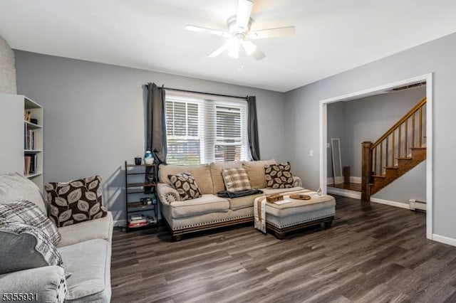 living room featuring a baseboard radiator, wood finished floors, a ceiling fan, stairway, and baseboards
