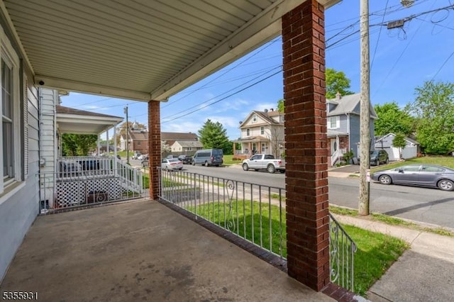 view of patio with covered porch and a residential view