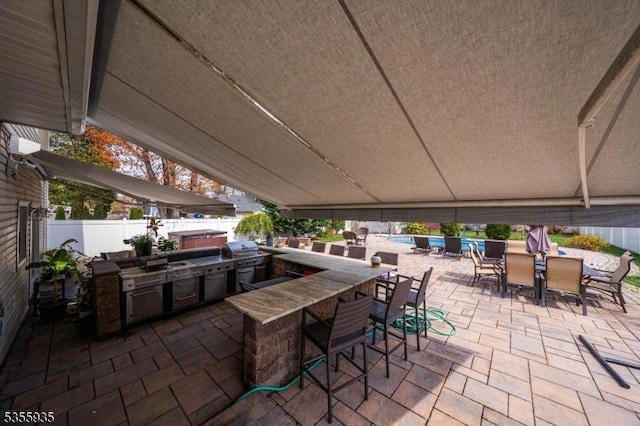 74 Emerald Pl, Clark Twp, NJ 07066 - view of patio featuring area for grilling, an outdoor bar, fence, and grilling area