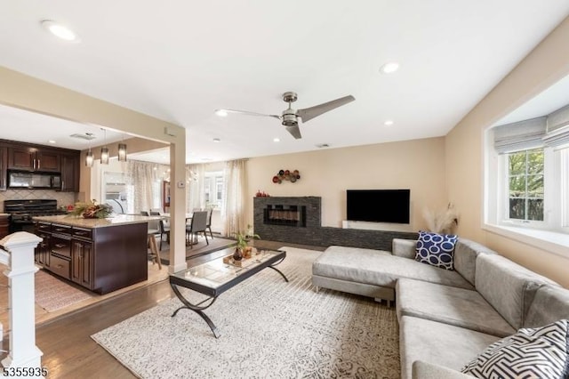 74 Emerald Pl, Clark Twp, NJ 07066 - living room featuring plenty of natural light, wood finished floors, ceiling fan, a glass covered fireplace, and recessed lighting