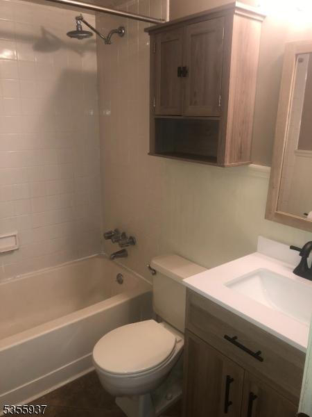 full bathroom featuring shower / tub combination, toilet, and vanity