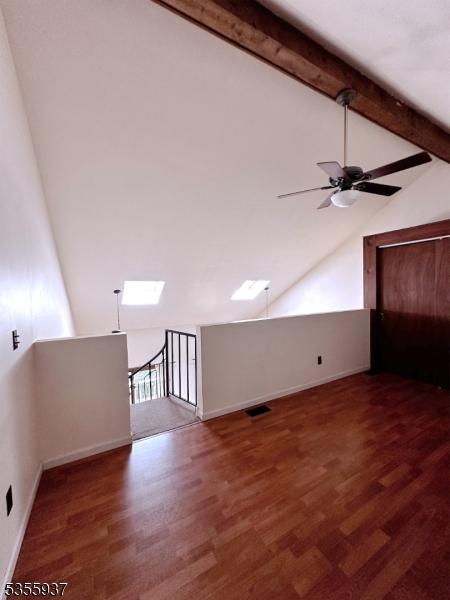 bonus room with ceiling fan, wood finished floors, and baseboards