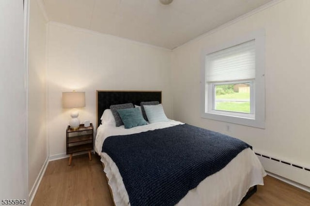 7 Capstan Rd, West Milford Twp, NJ 07480 - bedroom with a baseboard heating unit, wood finished floors, ornamental molding, and baseboards