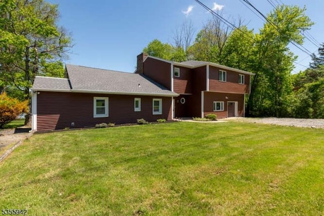 7 Capstan Rd, West Milford Twp, NJ 07480 - rear view of house featuring a lawn, driveway, a chimney, and a garage