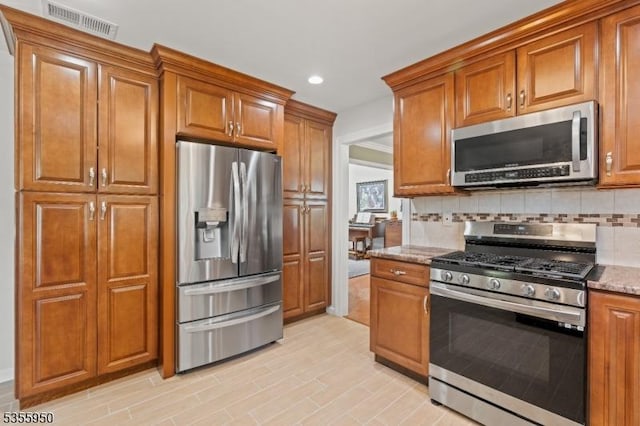 53 Woodland Ave, Morris Twp, NJ 07960 - kitchen with stainless steel appliances, brown cabinetry, light stone counters, decorative backsplash, and recessed lighting