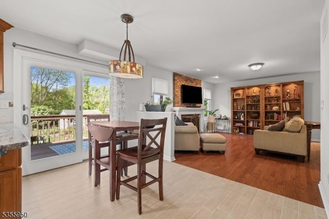 53 Woodland Ave, Morris Twp, NJ 07960 - dining space featuring light wood-type flooring and a large fireplace
